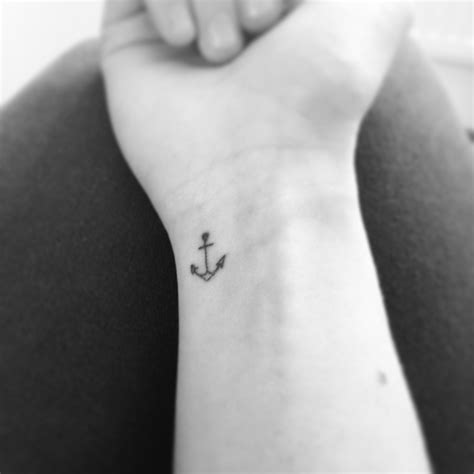 small anchor tattoo on wrist.